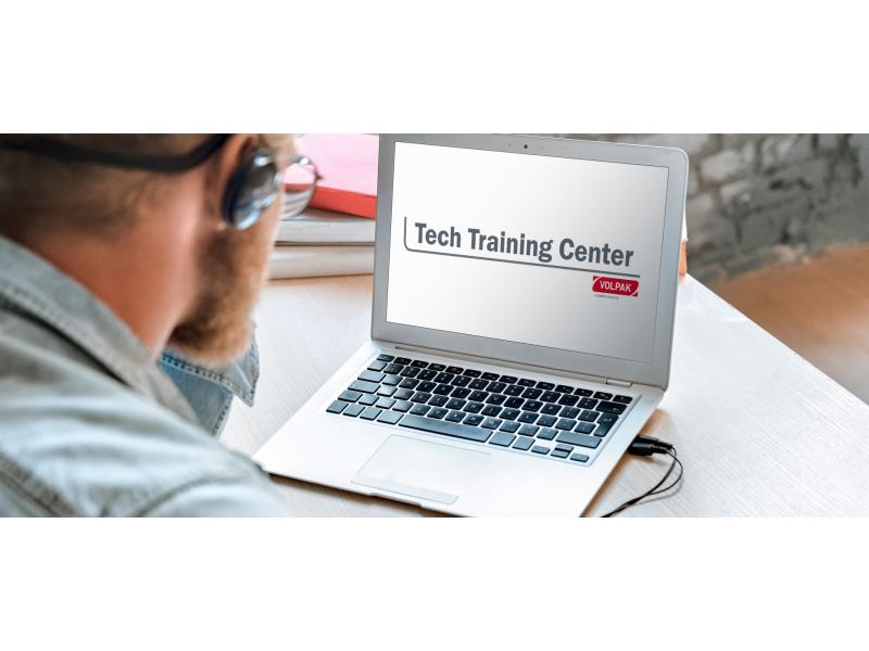 Man looking at his computer screen at the Volpak Tech Training Center online campus. 